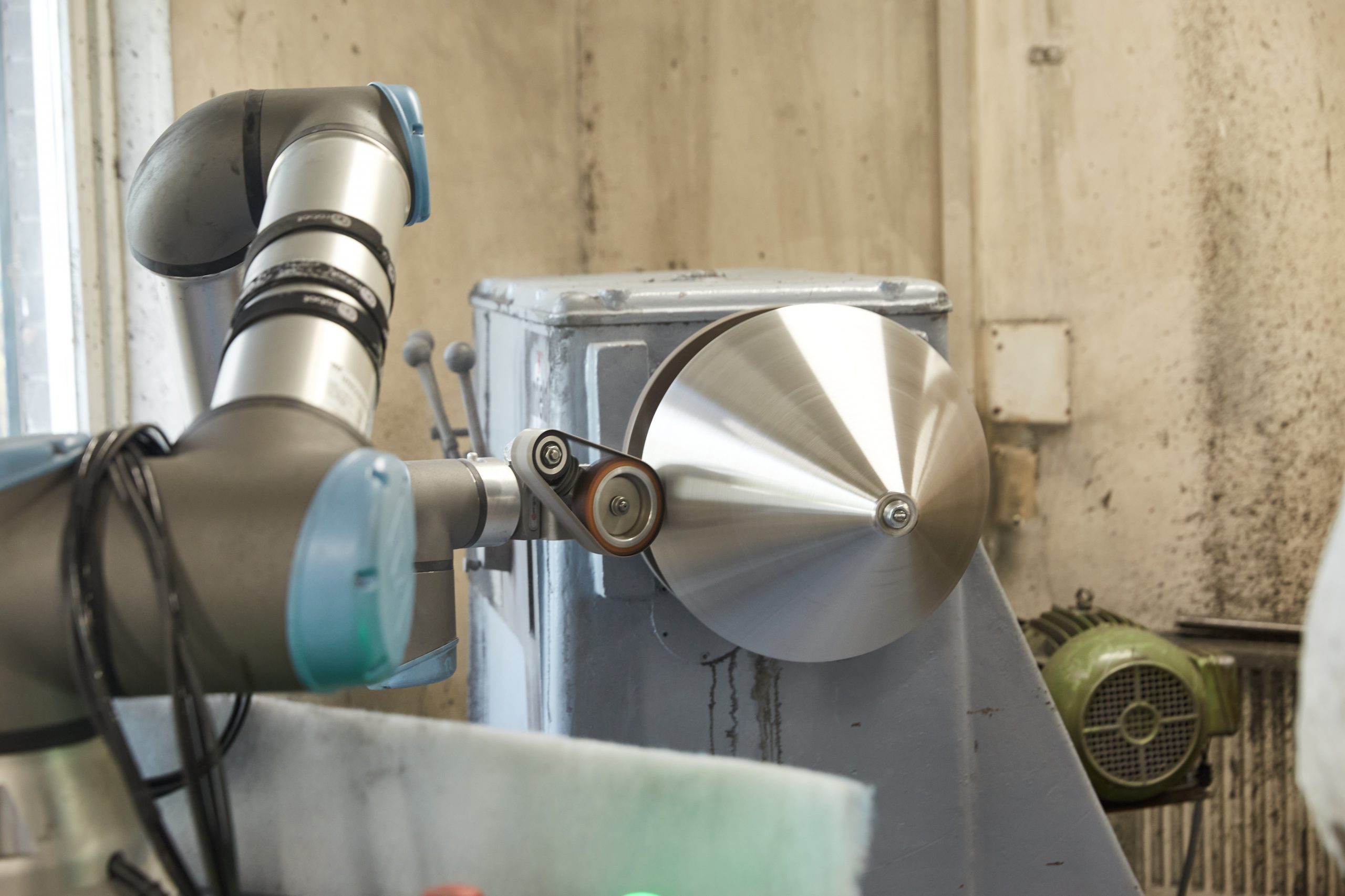 Metal polishing machine in the process of polishing a metal cone