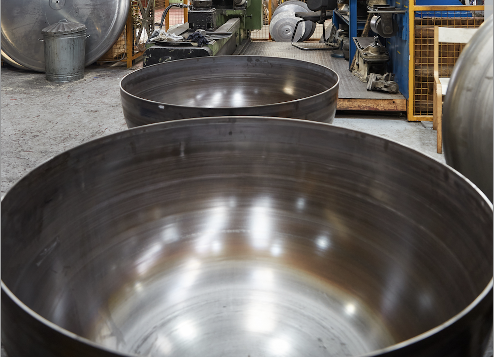 Large metal bowls in a metal spinning factory