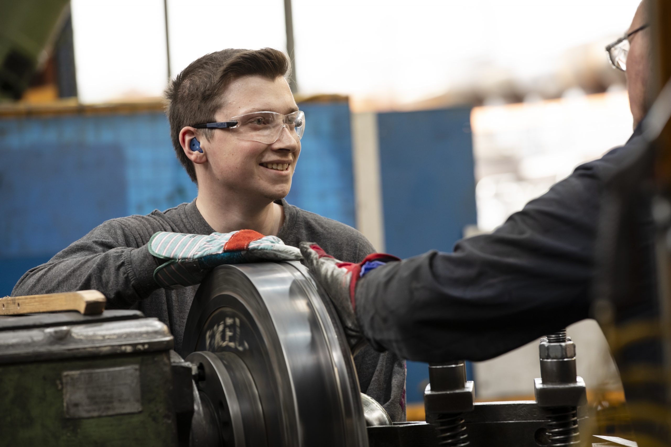 Two male metal spinners working